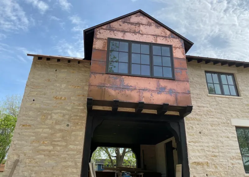 Copper metal panel facade on a stone building for Metal Roof Coating in Oconomowoc