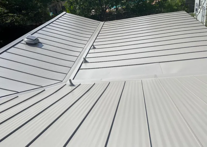 Solar attic fan installed on a metal roof for Roof Ventilation in Oconomowoc