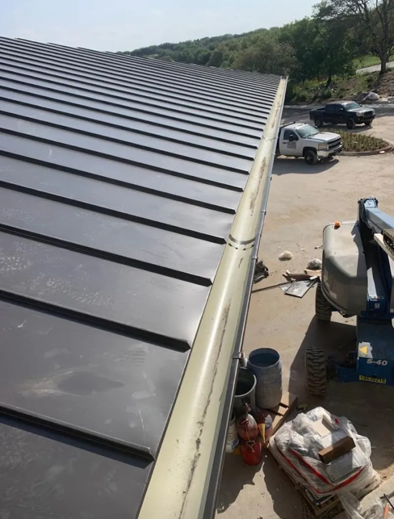 Standing seam panel and gutter detail on a metal roofing jobsite in Oconomowoc